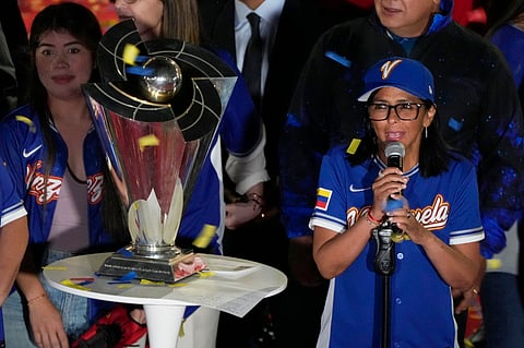 Venezuela's acting President Delcy Rodriguez, right, speaks next to the World Baseball Classic trophy a day after her team's victory over the United States in the championship match, at Miraflores presidential palace in Caracas, Venezuela, Wednesday, March 18, 2026.