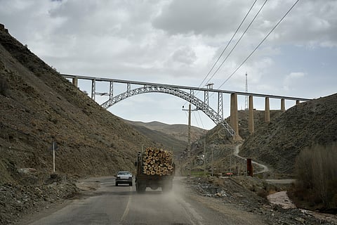 A truck loaded with logs and other vehicles drive along a road toward Tehran near the Turkish border on the outskirts of Razi, northwestern Iran, Saturday, April 4, 2026. (AP Photo/Francisco Seco)

