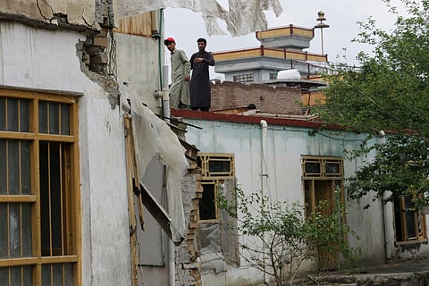 Residents inspect a building damaged by heavy flooding in Jalalabad, Afghanistan, Saturday, April 4, 2026. 