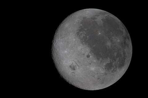 This image provided by NASA Monday, April 6, 2026, shows the Moon, the near side (the hemisphere we see from Earth) visible at the right side of the disk, identifiable by the dark splotches. At lower left is Orientale basin, a nearly 600-mile-wide crater that straddles the Moon’s near and far sides. Everything to the left of the crater is the far side. (NASA via AP)

