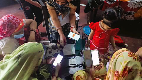 Women navigating an official registration portal in Ramgarh, Jharkhand 