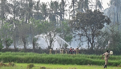 Officers dousing the fire caused by the firecracker blast