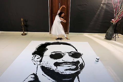 Dancer Aswathy Krishna painting a portrait of Fahadh Faasil while dancing