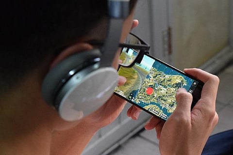 Representative image of a person playing a game on his mobile