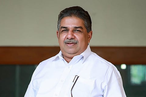 Image featuring Saji Cheriyan wearing a white shirt 