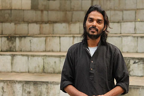 Somnath Waghmare in a black shirt standing on stairs