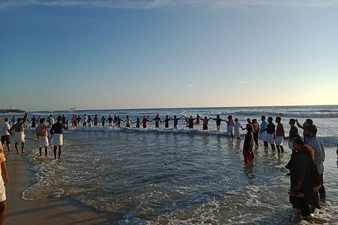 Kerala villagers form human chain to mark 1 year of protests against beach sand mining 