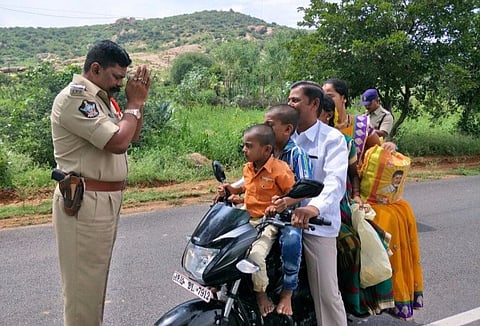 The story behind the viral photo of an Andhra cop folding hands before a family
