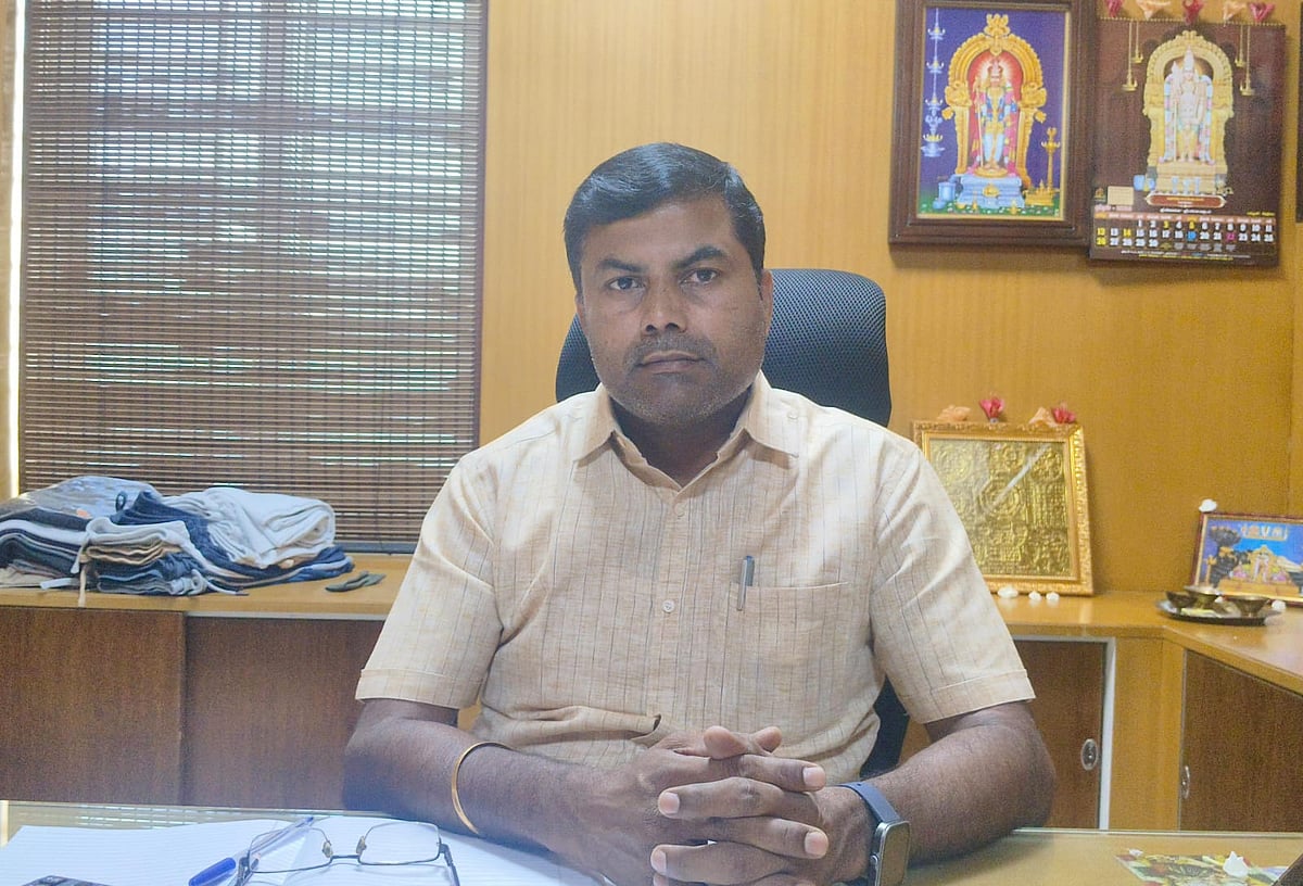 Mohan Kumar seated behind a desk at his office