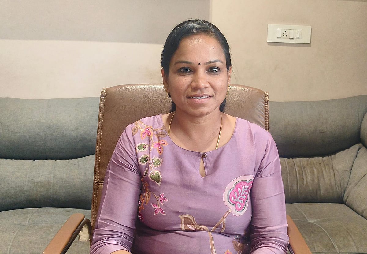 Miruthala Nataraj in a violet kurta, seated on a brown chair