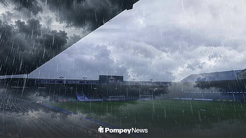 General view of Portsmouth's Fratton Park with rain pouring and storm clouds above