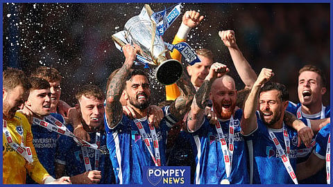 Marlon Pack lifts the League One trophy for Portsmouth.