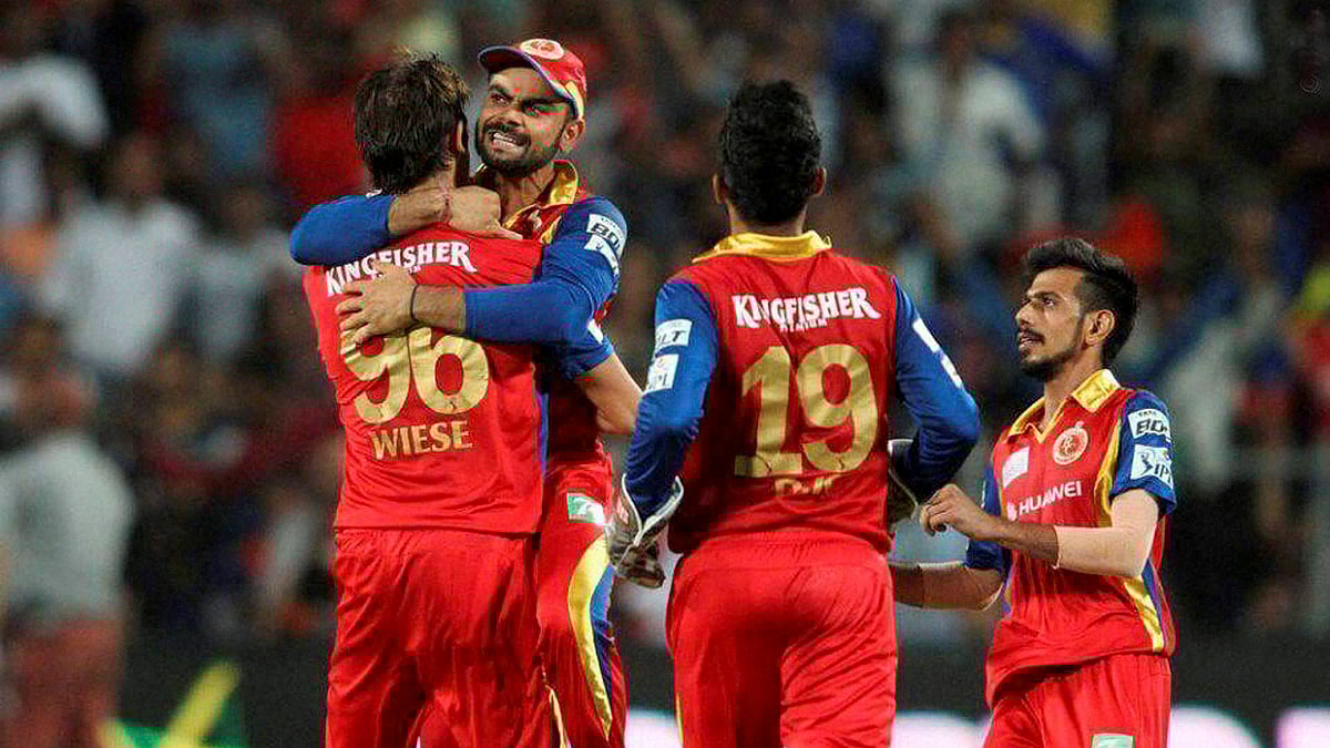 RCB captain Virat Kohli celebrates with David Wiese  for getting RR captain Steven Smith’s wicket during the eliminator match of the IPL 2015 at the MCA International Stadium in Pune. (Photo: PTI)