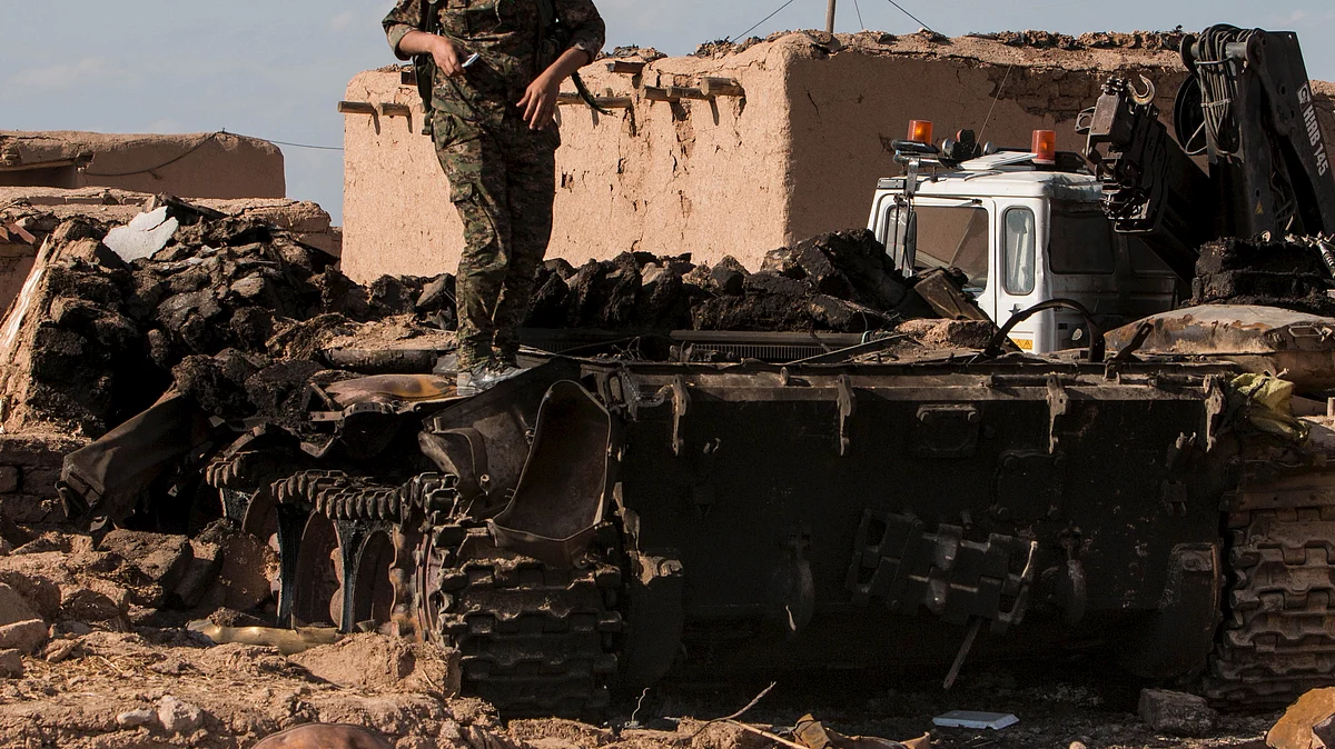 

A Kurdish People’s Protection Units (YPG) fighter stands atop of a burnt tank that belonged to Islamic State. (Photo: Reuters) 