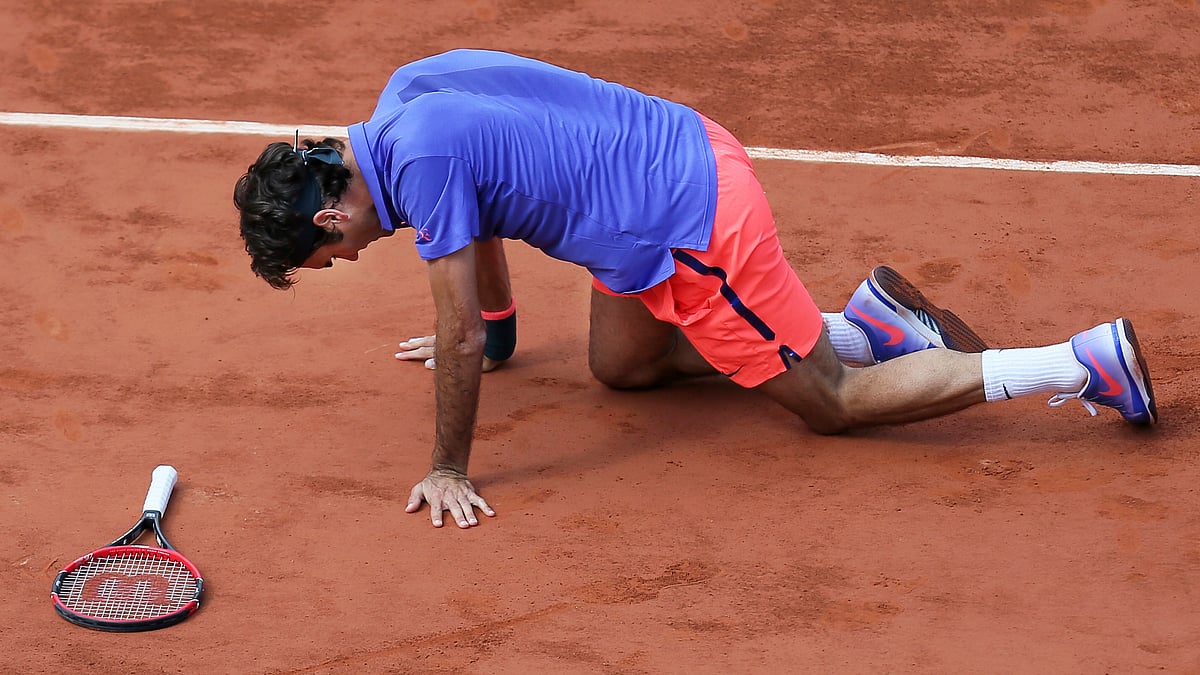 Switzerland’s Roger Federer gets up after slipping in the quarterfinal match of the French Open tennis tournament against Switzerland’s Stan Wawrinka. (Photo: AP) 