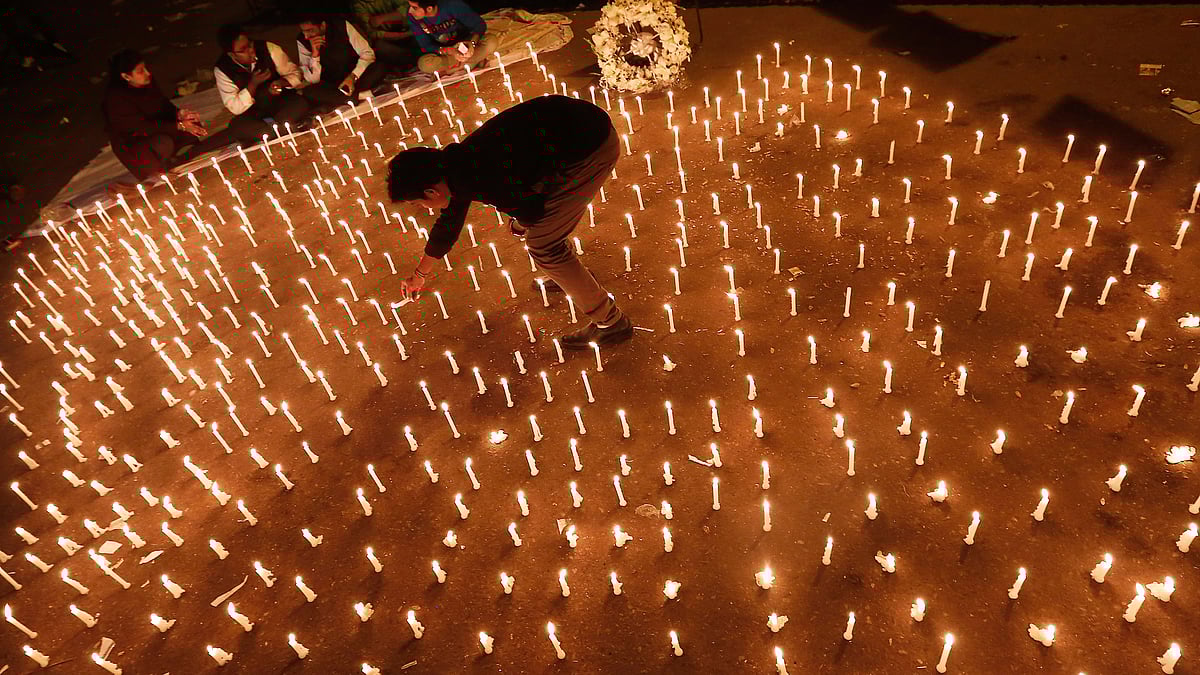 A protester lights candles during a candlelight vigil to mark the first anniversary of the Delhi gang rape. (Photo: Reuters)
