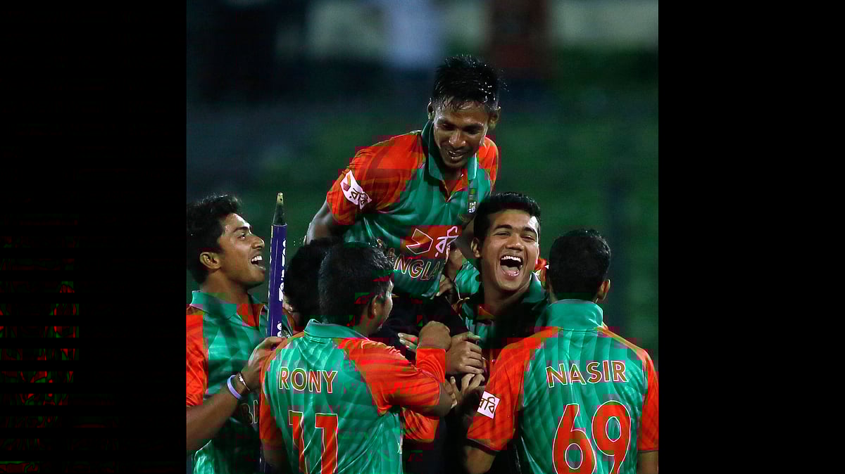 Bangladesh’s players lift Mustafizur Rahman, center, as they celebrate their win over India on Sunday. (Photo: AP)