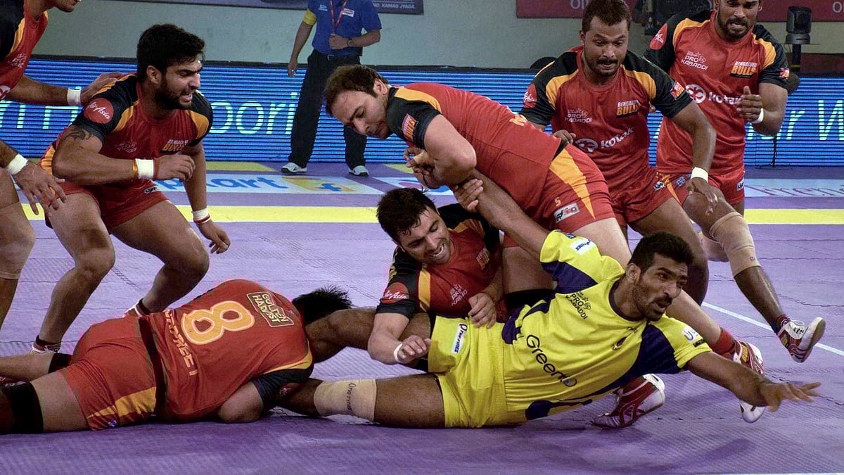 Players in action during a Pro Kabaddi League match between Telugu Titans (Yellow) and Bengaluru Bulls (Red) at Patliputra Sports Complex in Patna on Friday. (Photo: PTI)