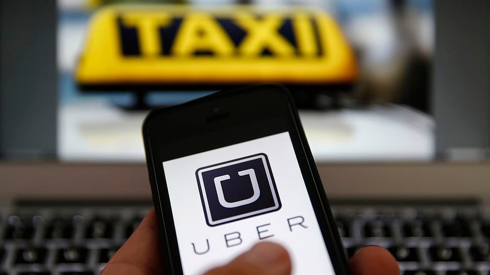 An illustration shows the logo of car-sharing service app Uber on a smartphone. (Photo: Reuters) 