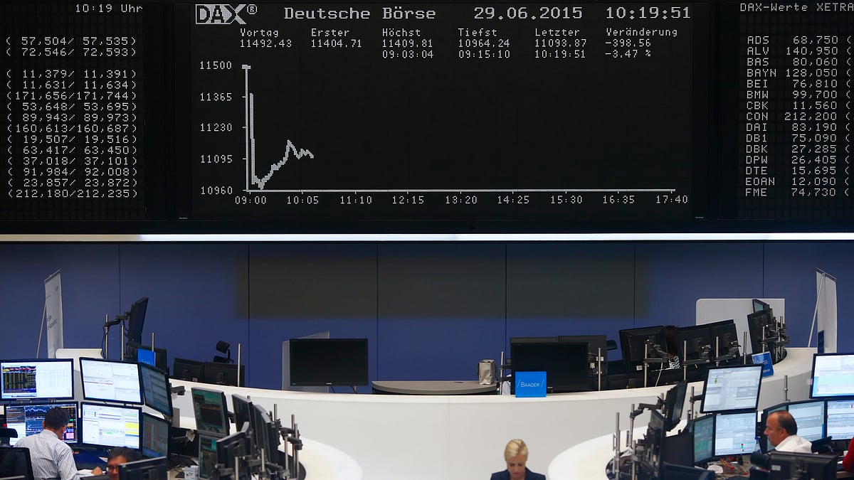 Traders sit at their desks in front of the DAX board at the Frankfurt stock exchange, Germany. (Photo: Reuters) 