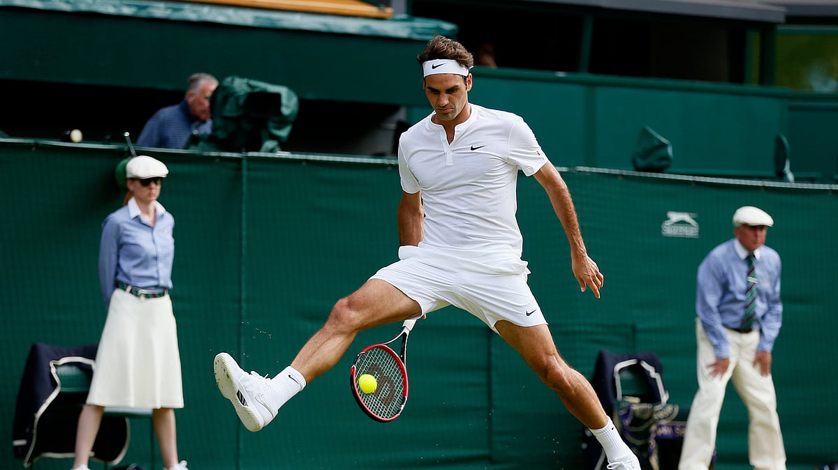 Roger Federer of Switzerland hits a shot through his legs during his match against Sam Querrey of the USA at the Wimbledon Tennis Championships in London. (Photo: Reuters)