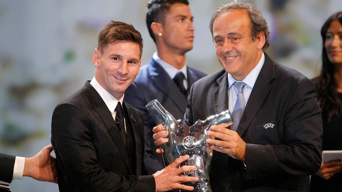 UEFA President Michel Platini, right, gives the trophy for best  player of the year to Barcelona’s Lionel Messi of Argentina. (Photo: AP)