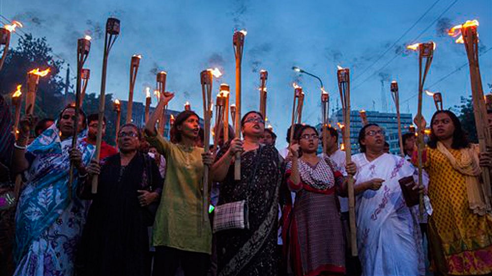 Bangladeshi secular activists participate in a torch rally held to protest against the killing of blogger Niloy Chottopadhay, 40, in Dhaka, Bangladesh (Photo: AP)