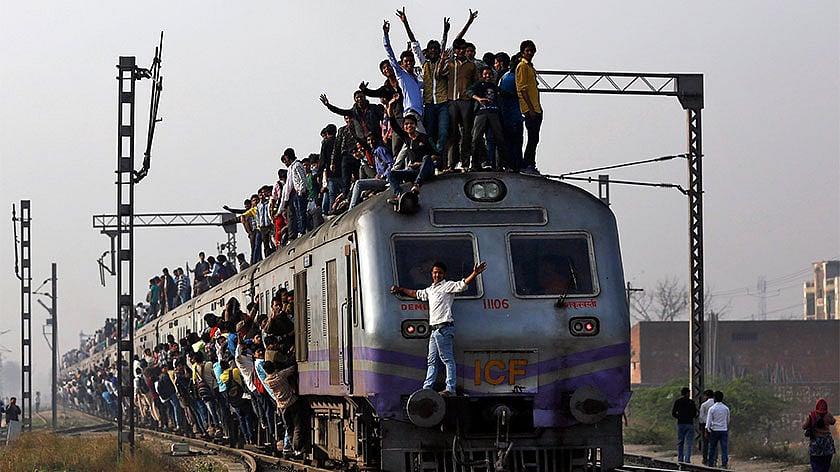 Passengers travel on an overcrowded train on the outskirts of New Delhi. (Photo: Reuters)
