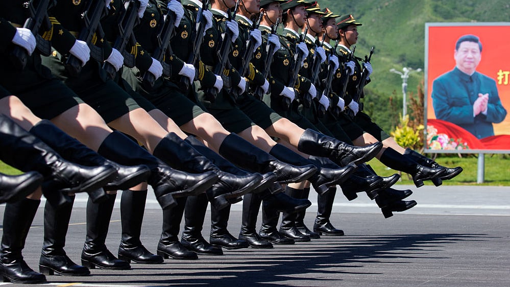 Female Chinese troops practice marching near a portrait of Chinese President Xi Jinping ahead of a Sept. 3 military parade. (Photo: AP)