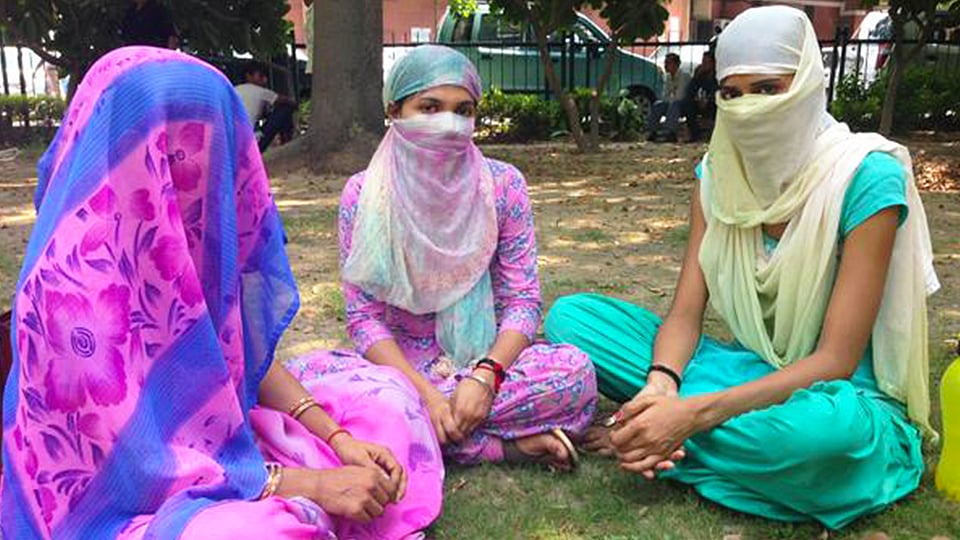 The two sisters (centre, right) who’ve been ‘sentenced’ to be gangraped and paraded naked by a Khap Panchayat in Uttar Pradesh. (Photo: Amnesty India)
