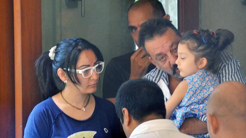 Actor Sanjay Dutt, convicted for 1993 Mumbai blasts, kisses daughter Iqra before leaving for Yerawada jail. (Photo: Yogen Shah)