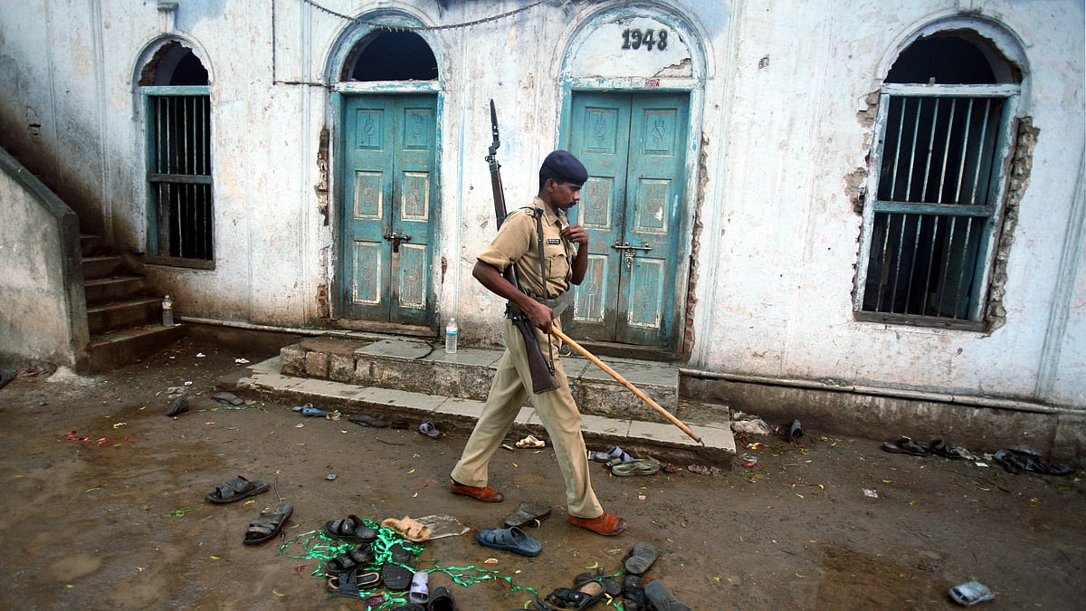 A policeman walks past torn slippers of blast victims inside a mosque in Malegaon, a day after bomb blasts killed 32 people and wounded dozens. (Photo: Reuters)