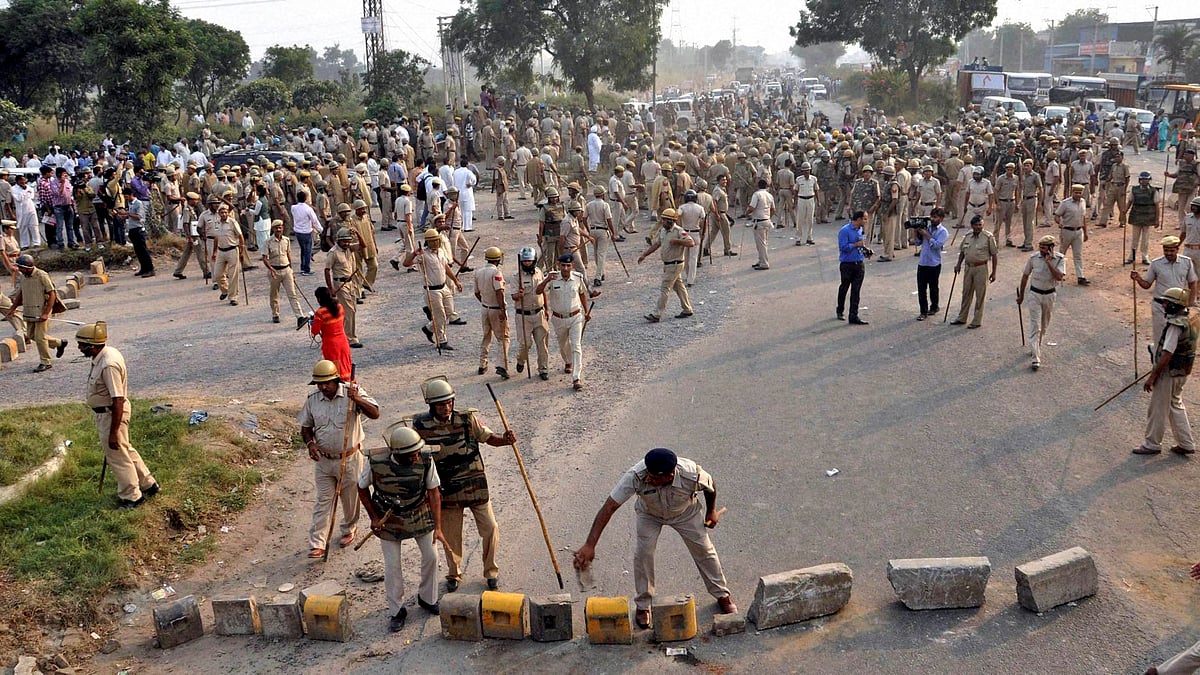 Police clearing a road that was blocked by the villagers during a protest against Sunpedh village incident in Faridabad on Wednesday. (Photo: PTI)