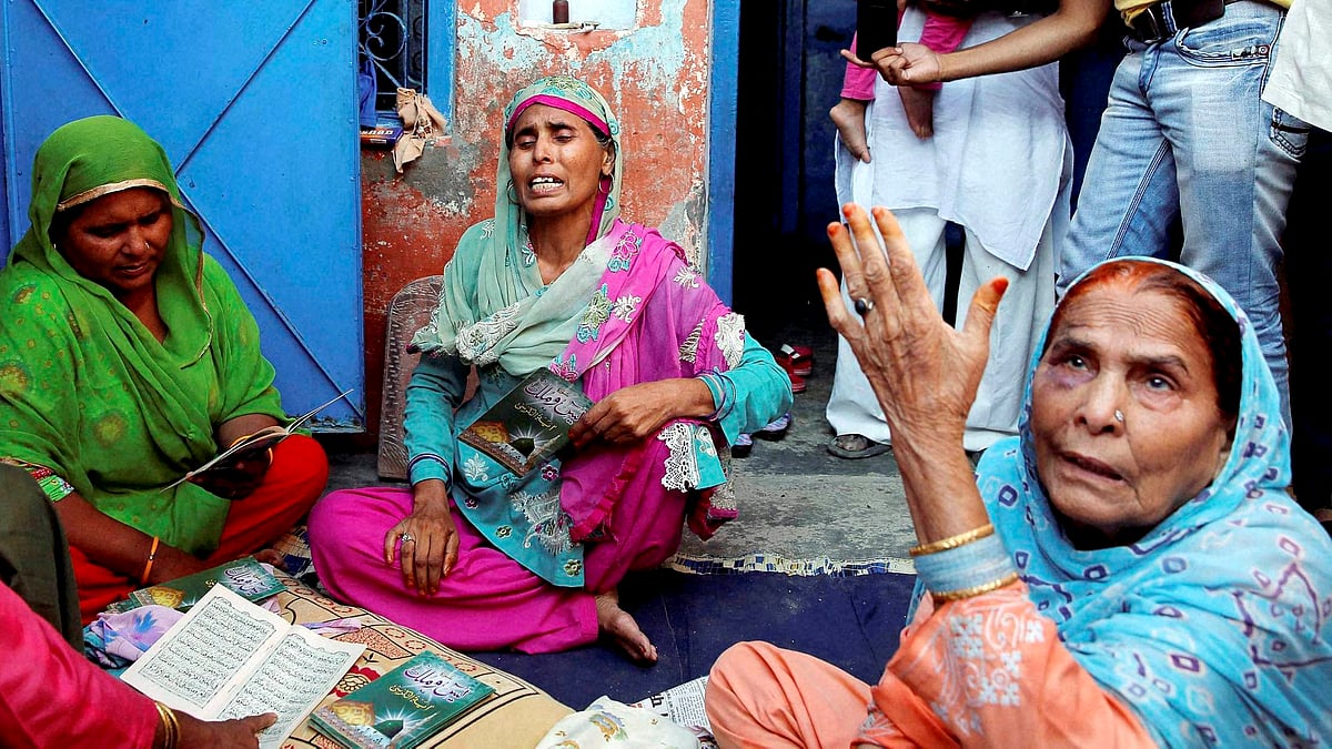 Relatives mourn the death of farmer Mohammad Akhlaq at his home in Bisara village about 45 kilometers from New Delhi on Wednesday. (Photo: PTI)