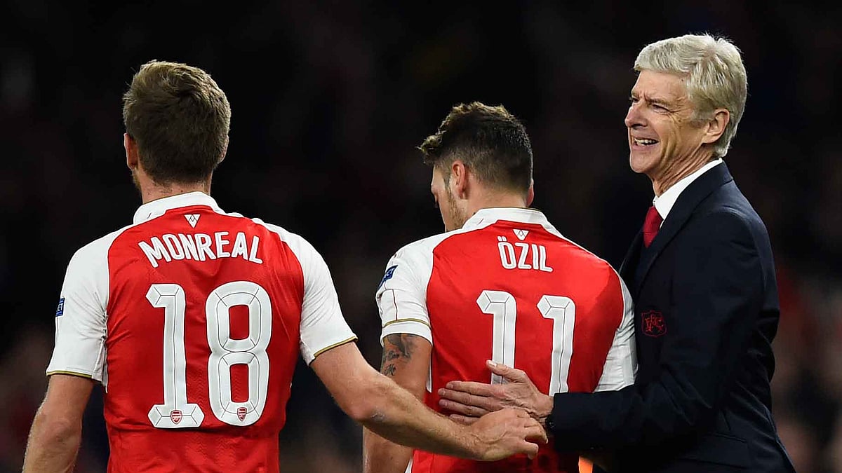 Mesut Ozil celebrates with manager Arsene Wenger after scoring the second goal for Arsenal. (Photo: Reuters)