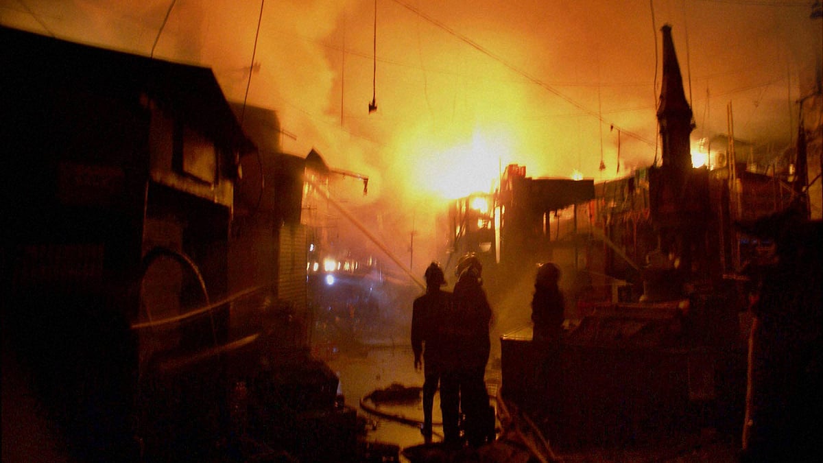 Firefighters in action after a massive fire broke out in Crawford market in Mumbai on Sunday. (Photo: PTI)