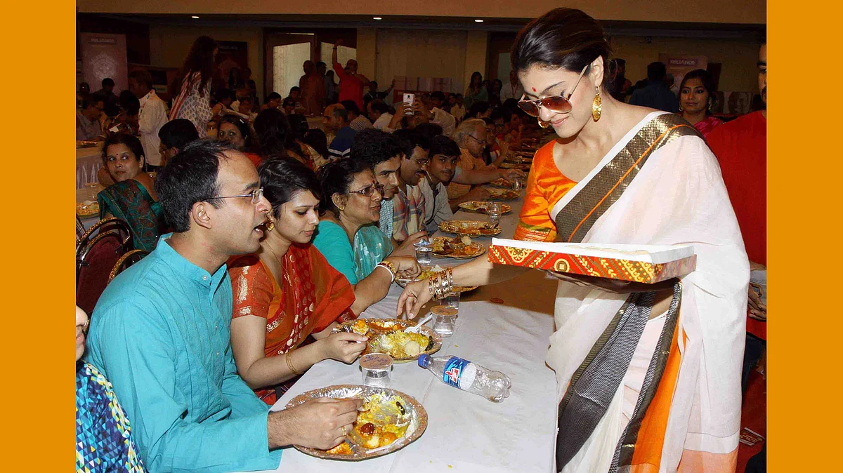 Kajol distributes sweets at a Durga Puja pandal in Mumbai (Photo: Yogen Shah)