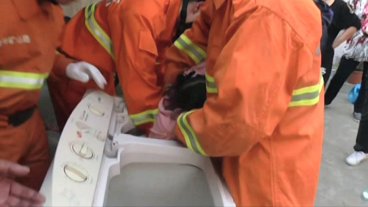 Firemen rescued a 4-year-old girl who got stuck in a washing machine in Xuzhou, China. (Photo: AP/Newsflare screengrab)