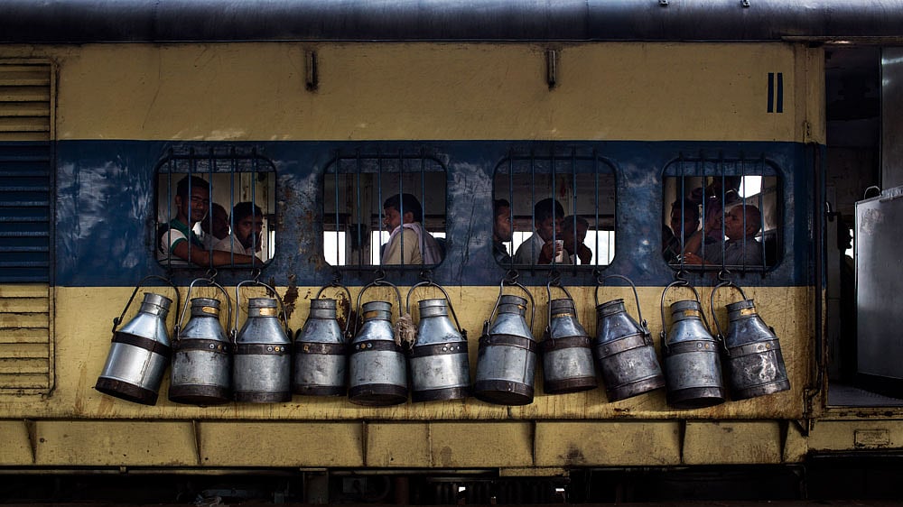 Milkmen from surrounding towns delivering milk to neighbourhoods across the national capital. (Photo: AP) 