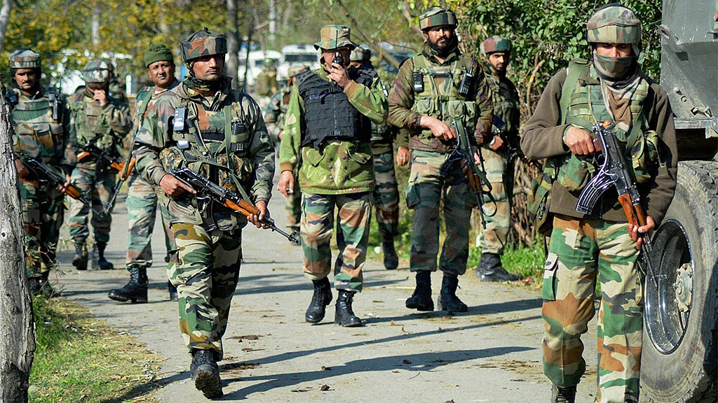 Army personnel in action during an encounter operation against militants in Khandaypora, in Kulgam District of South Kashmir. (Photo: PTI)