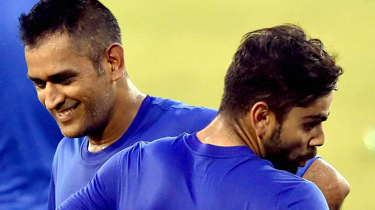 <b>The captain and his deputy: </b>MS Dhoni and Virat Kohli share a light moment during their training session ahead of the 2nd T20 against South Africa. (Photo: PTI)