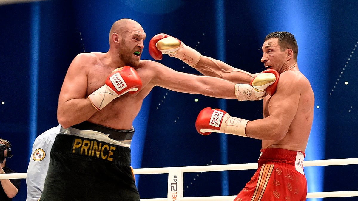Ukraine’s Wladimir Klitschko, right, and Britain’s Tyson Fury exchange blows as Fury wins the world heavyweight title fight for Klitschko’s WBA, IBF, WBO and IBO belts in the Esprit Arena in Duesseldorf, western Germany on Sunday, Nov. 29, 2015. (Photo: AP)