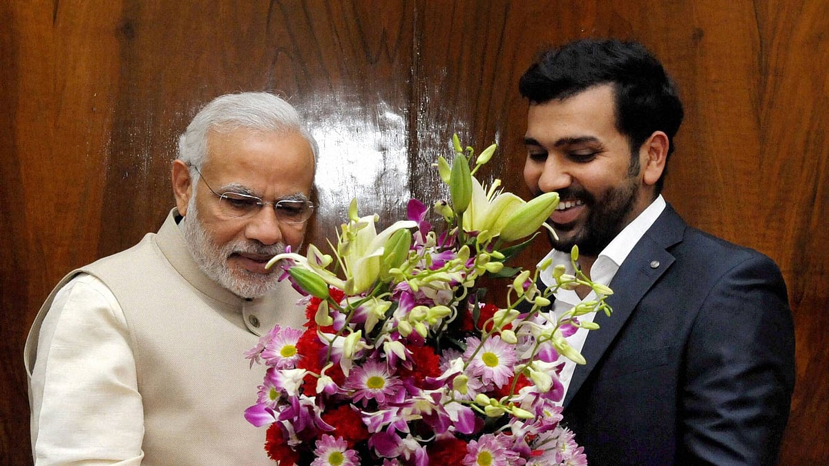 Cricketer Rohit Sharma greets Prime Minister  Narendra Modi while handing him his wedding invitation at the Parliament House in New Delhi on Wednesday. (Photo: PTI)