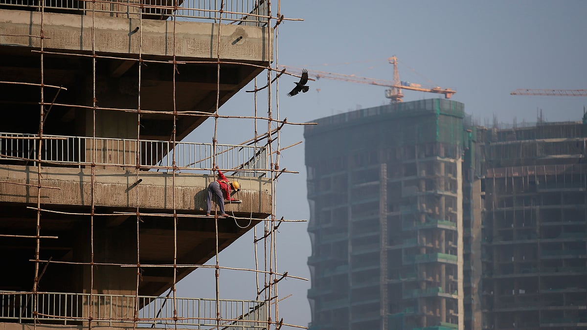 A labourer stands on wooden scaffolding as he works at the construction site of a commercial building in Mumbai’s central financial district January 16, 2015. (Photo: Reuters)