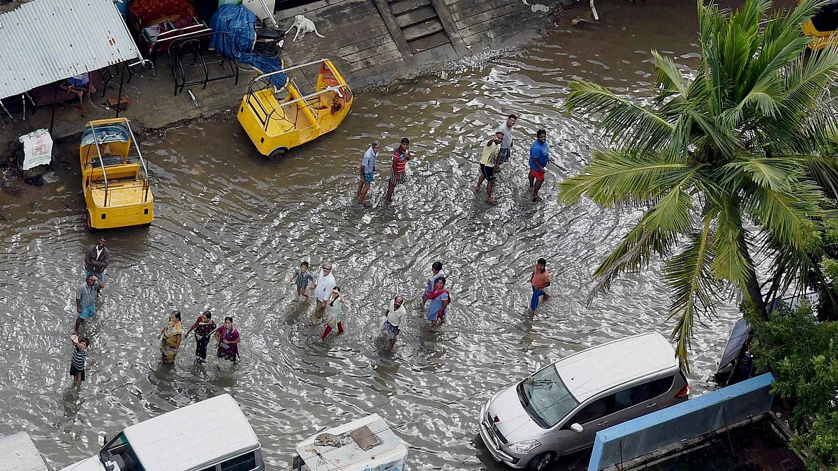 People wait for food packets in a flood-hit locality of Chennai city on Thursday following heavy rains. &nbsp;(Photo: PTI)