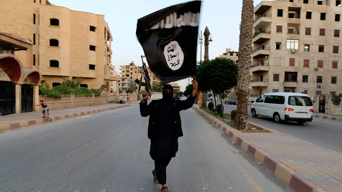 An ISIS member with the terror group’s flag in Iraq. (Photo: Reuters)&nbsp;
