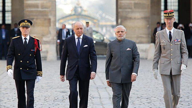 File photo of PM Narendra Modi, accompanied by French Foreign Minister Laurent Fabius. (Photo Courtesy: Twitter/@francediplo)
