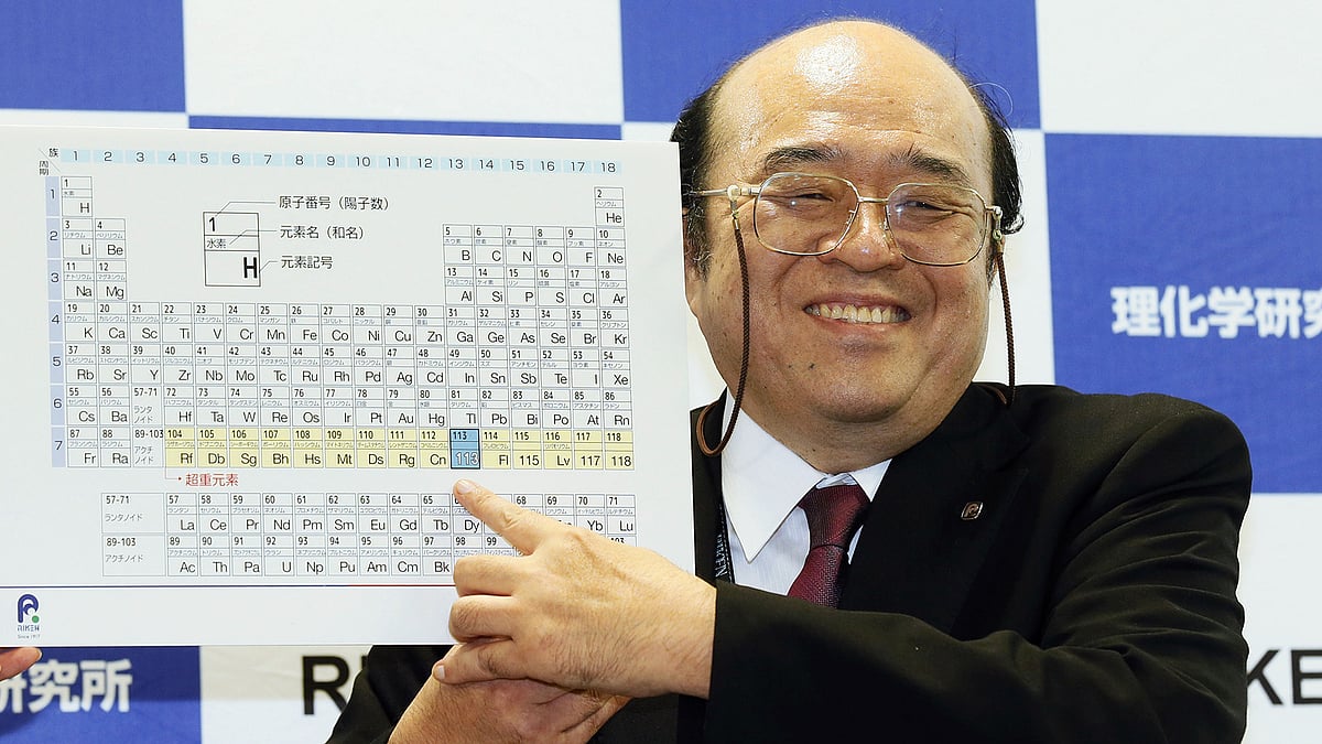 Kosuke Morita of Riken Nishina Center for Accelerator-Based
Science points at periodic table of the elements. (Photo: AP)