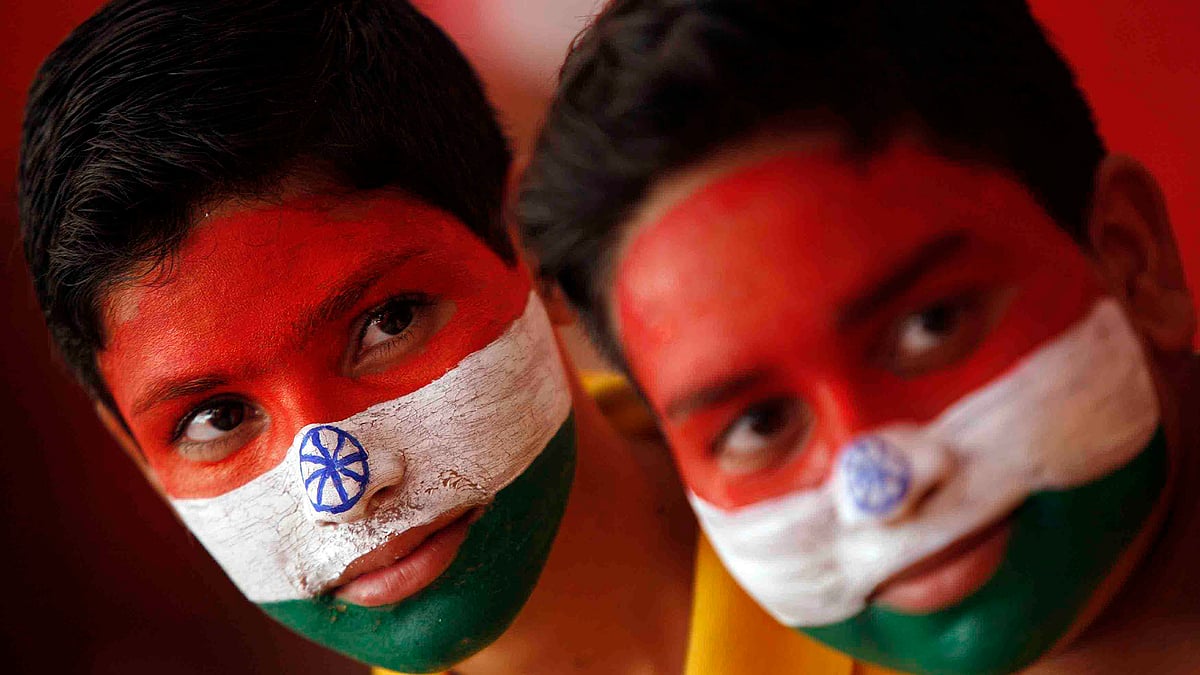 Schoolchildren get their faces painted in the colours of India’s national flag (Photo: Reuters)