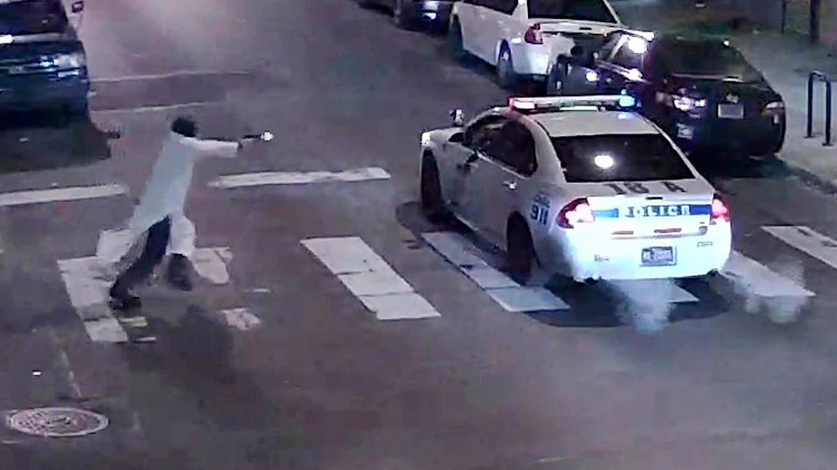 A gunman approaching a Philadelphia Police vehicle in which Officer Jesse Hartnett was shot. (Photo: Reuters)